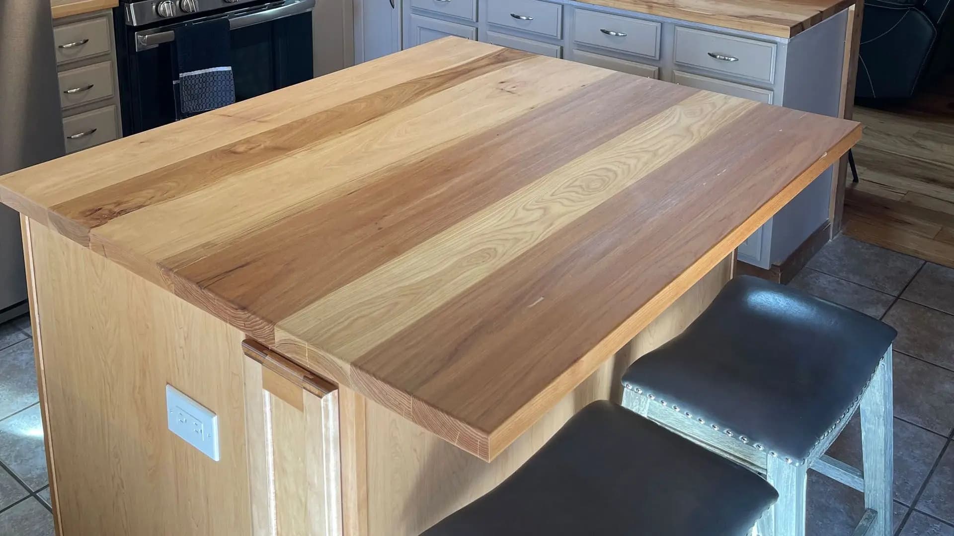 a wooden table with chairs in a kitchen