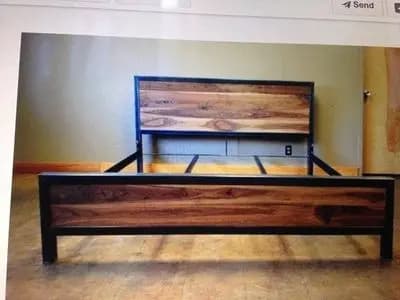 a wooden bed frame with a metal frame