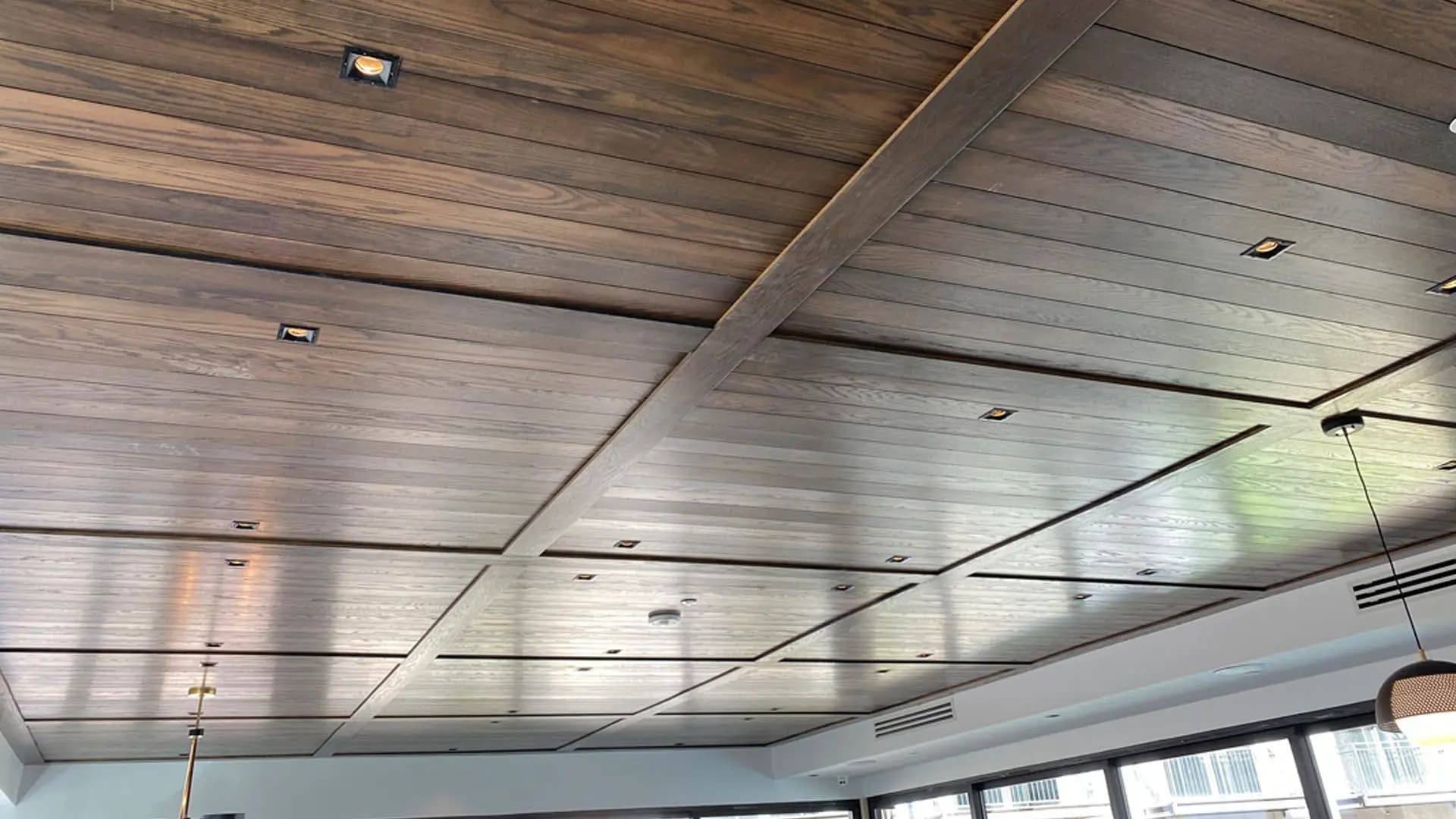 a wood paneled ceiling with lights