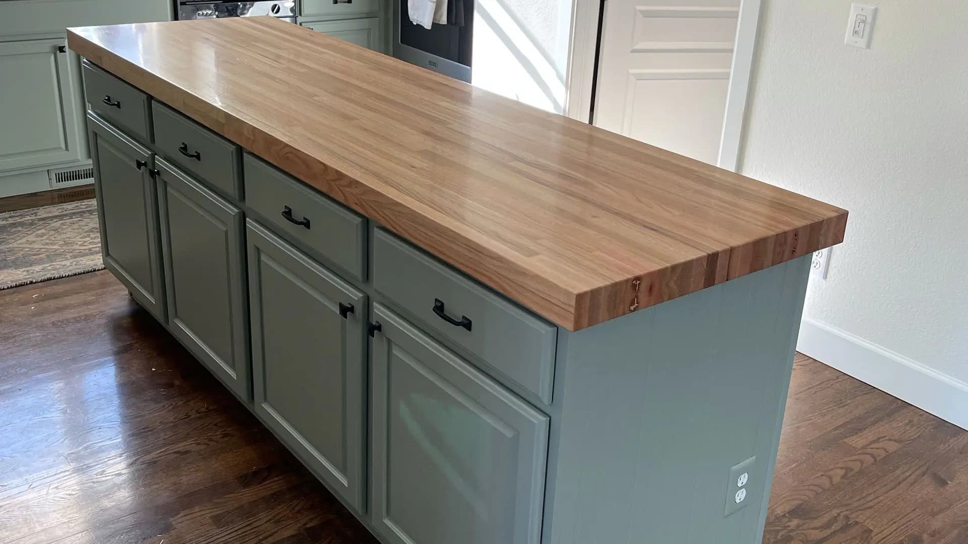 a kitchen island with a wood counter top