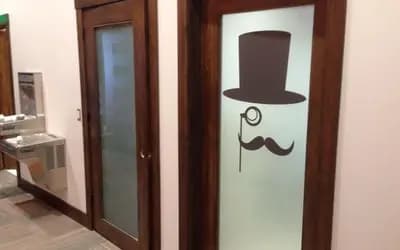 a door with a picture of a hat and mustache