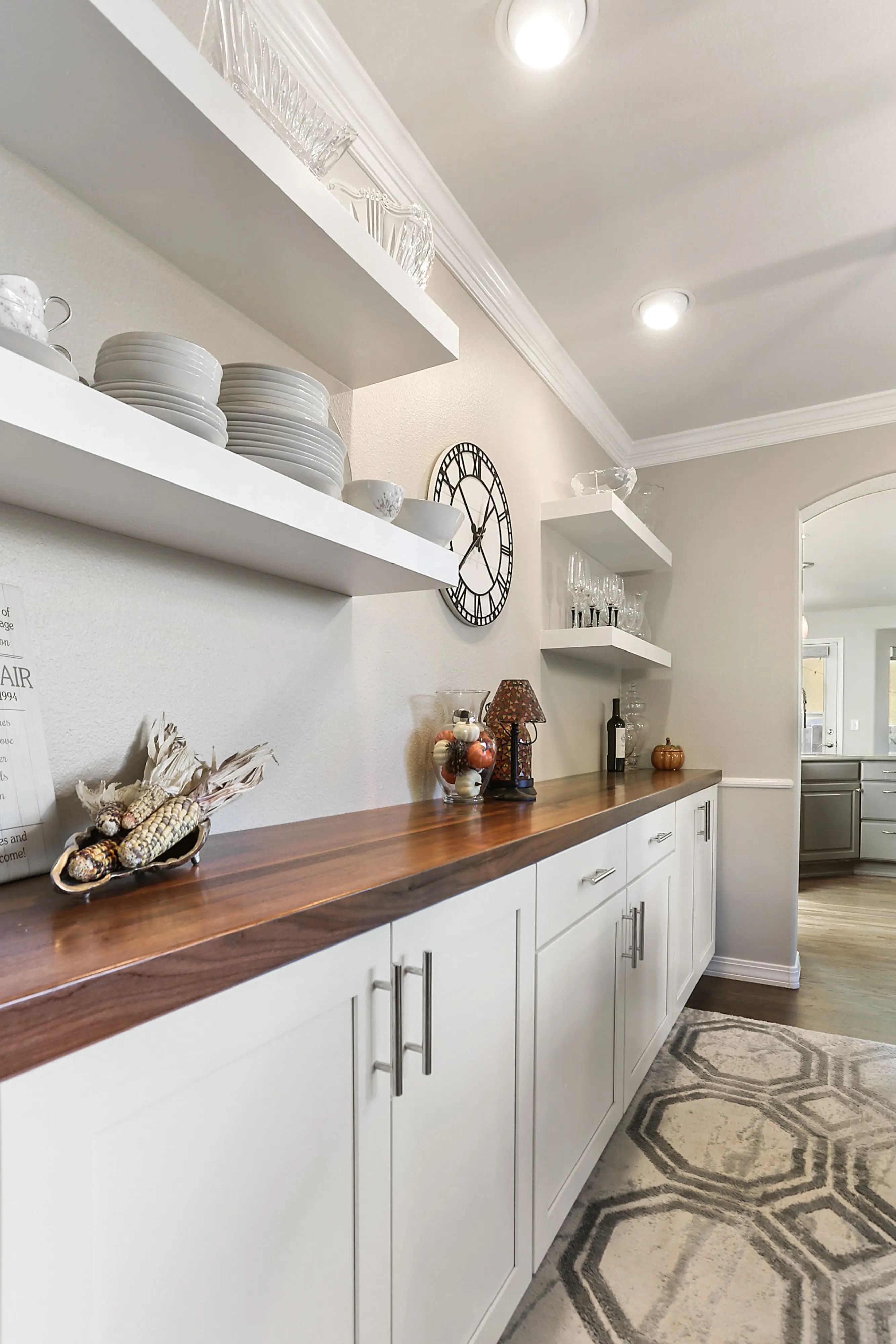 a shelf with plates and a white wall