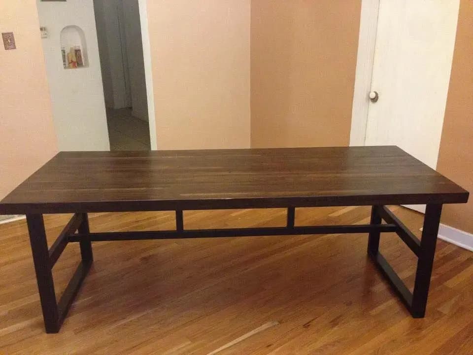 a wooden table with a bench in a room