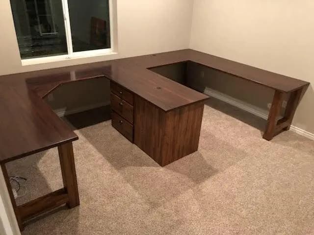 a corner desk in a room