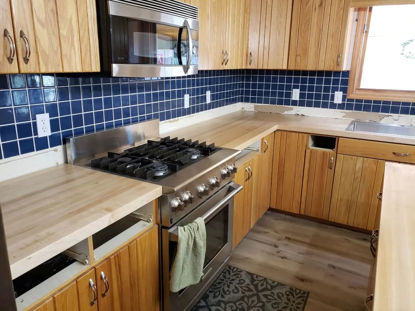 a kitchen with wood cabinets and a stove