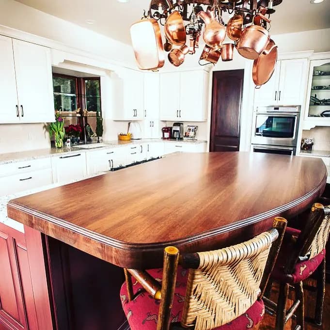 a kitchen with a table and chairs