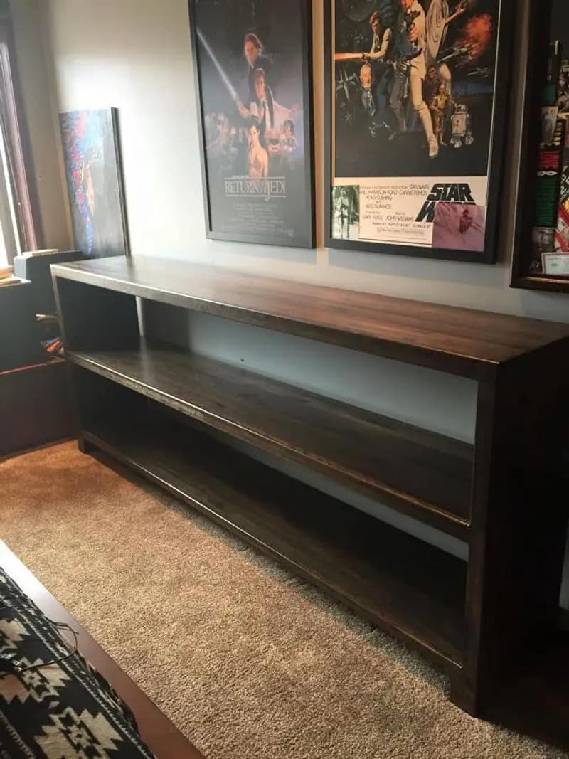 a shelf with posters on the wall