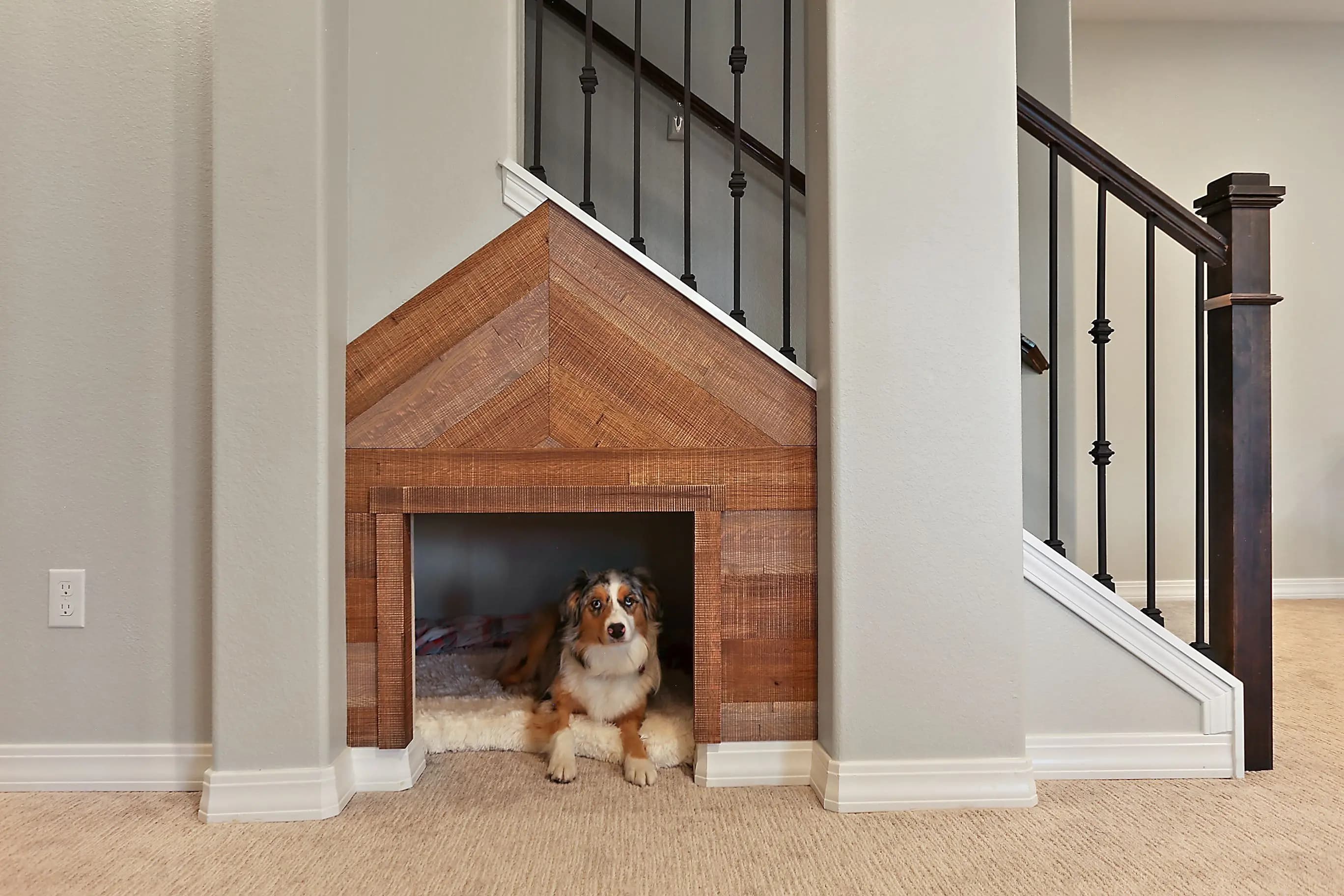 a dog house below a staircase