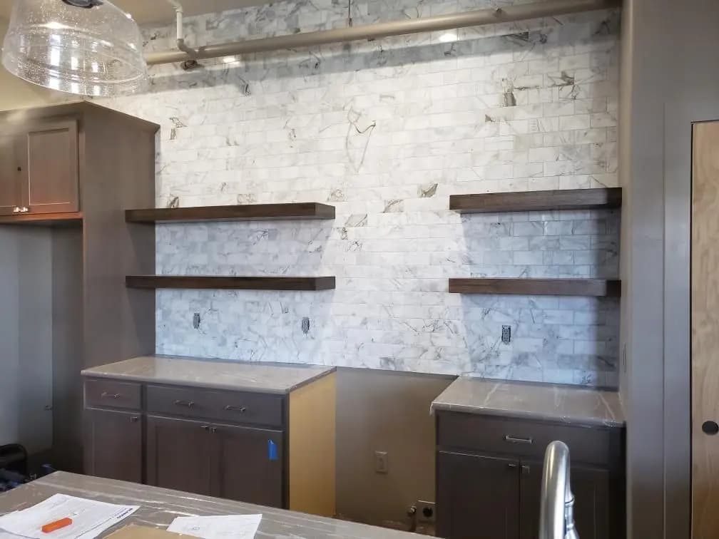 a kitchen with marble walls and cabinets